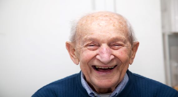 GettyImage elderly man laughing at home 570 x 310