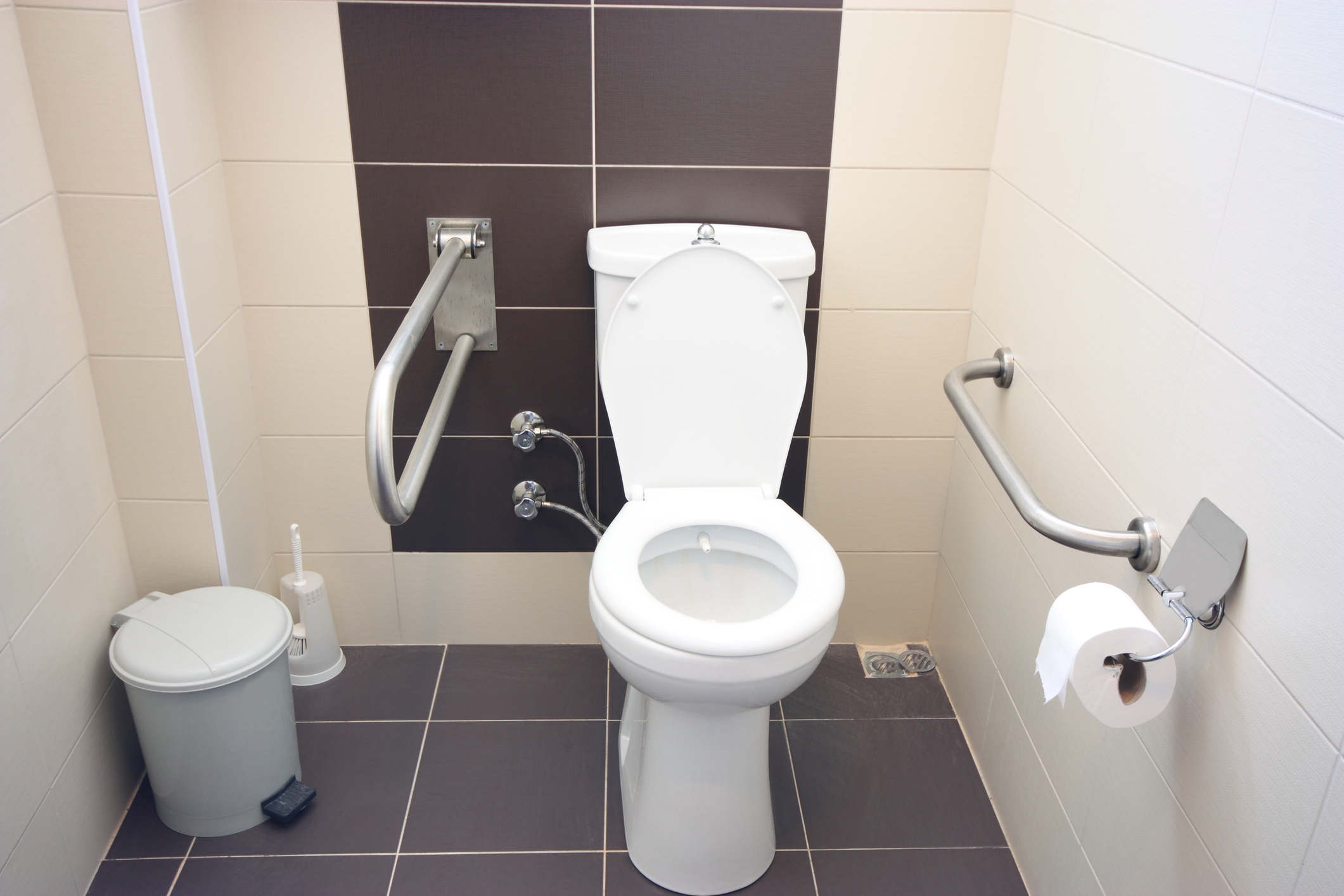 A toilet with adaptations for disabled person use.