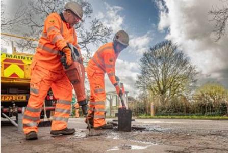 Workmen repairing a pothole